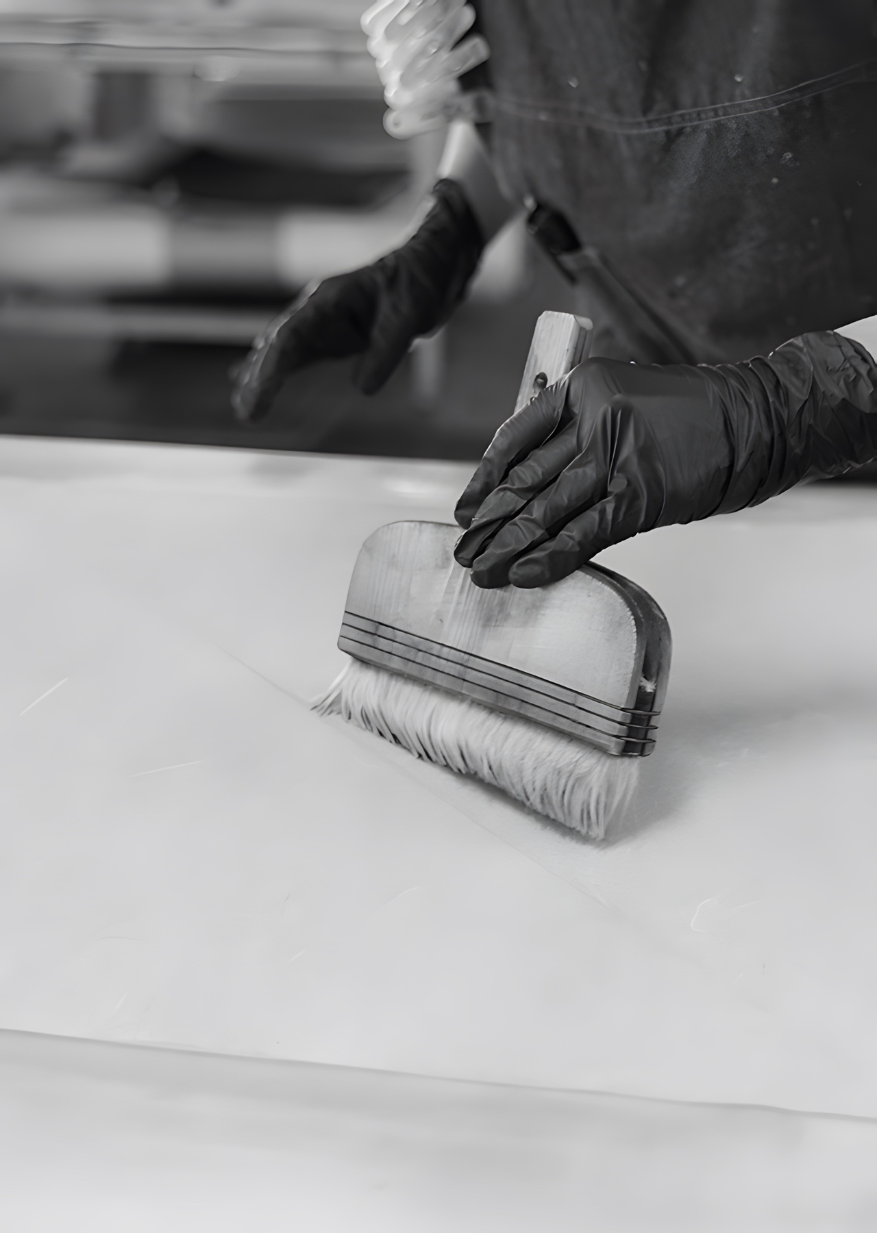 A wide brush drawn across a sheet of washi