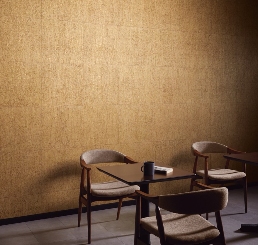 A café wall in golden washi with vertical creases